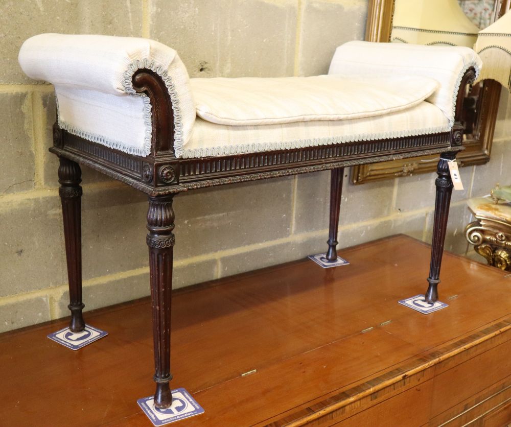 A Hepplewhite style carved mahogany window seat on turned fluted legs, W.94cm, D.40cm, H.64cm